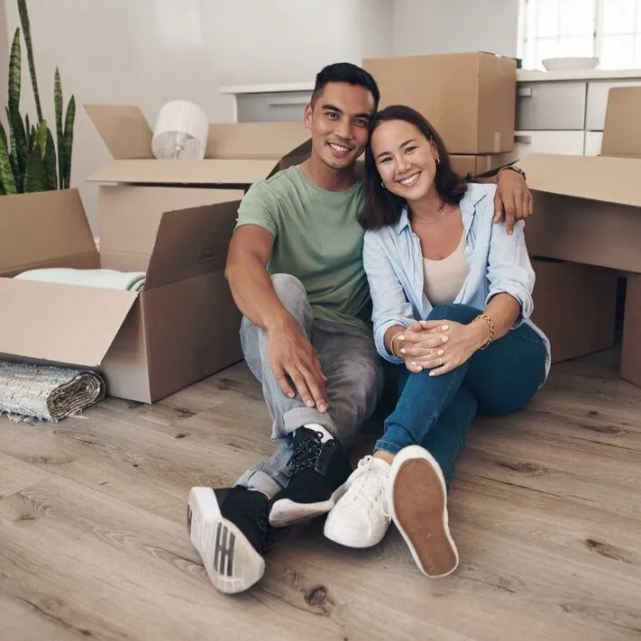 A happy couple amongst packing boxes