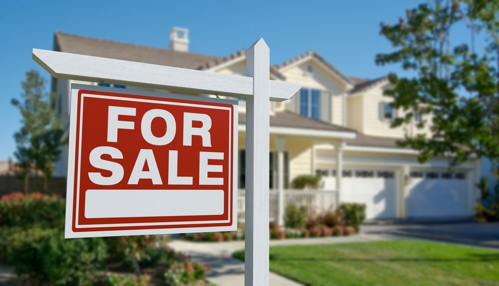 For sale sign posted outside of a home