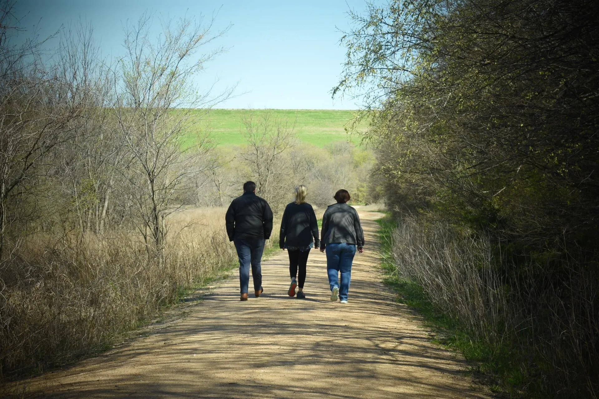 Residents walking on a trail near Lewisville Townhomes