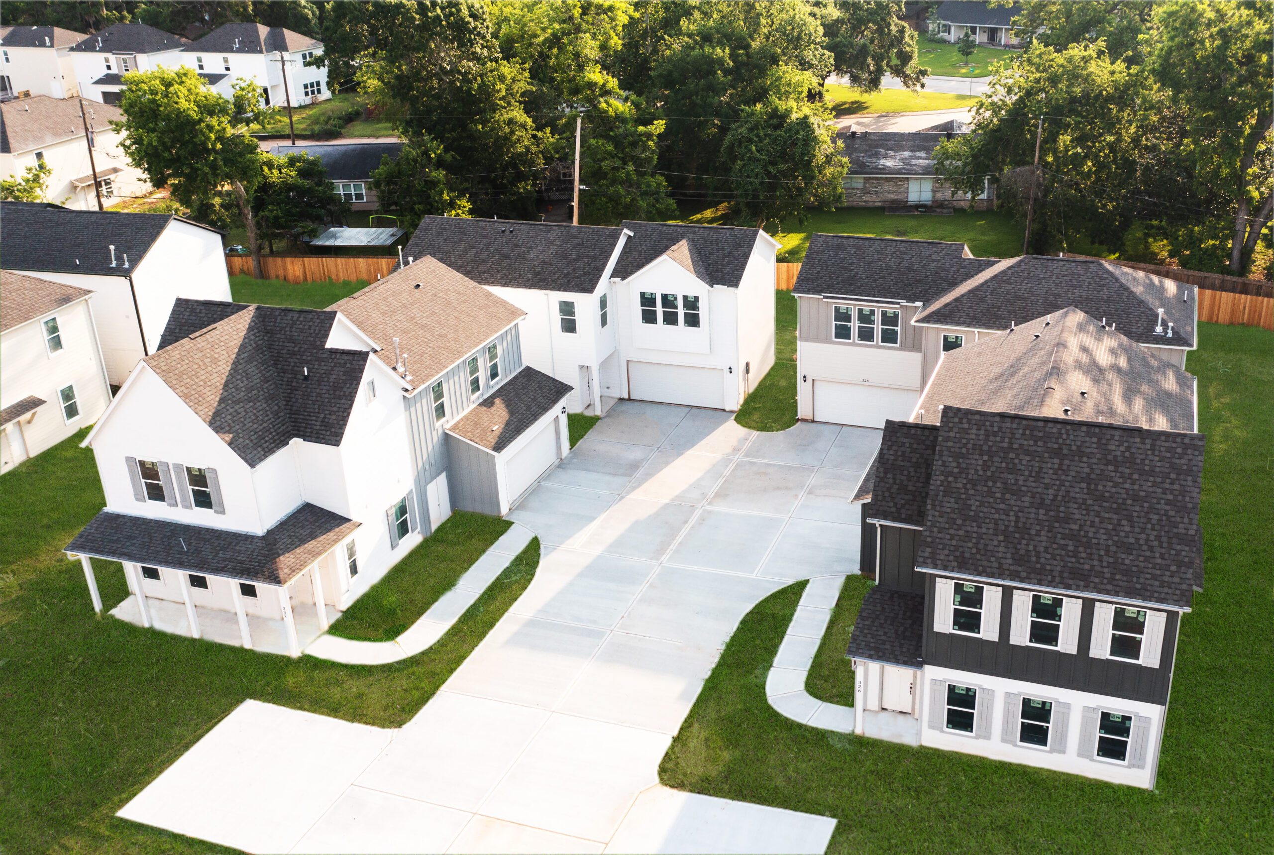 Exterior of multiple black roof and white homes.